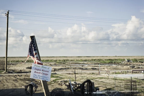 American flag standing by the slabs at Holly Beach in Louisiana after hurricane Catarina washed the town away