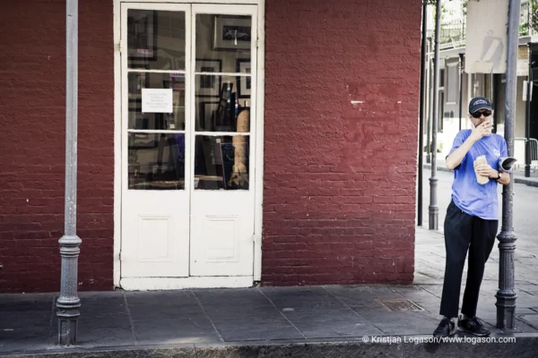 Man standing smoking at a street corner in Louisiana 2006