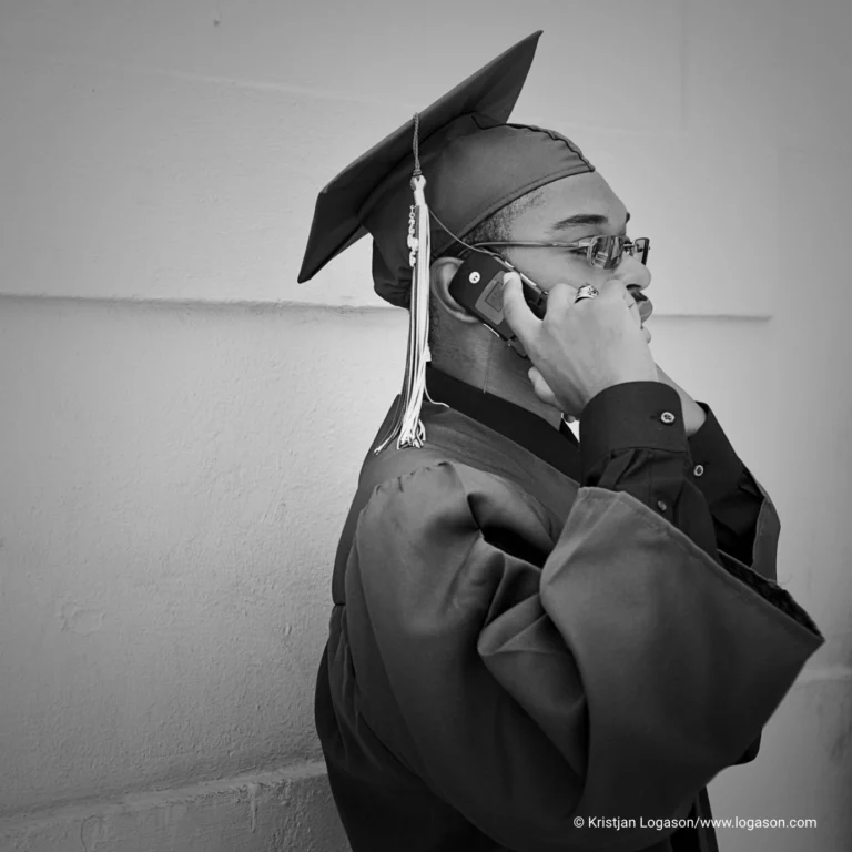 Graduating student talking on a phone. New Orleans, Louisiana