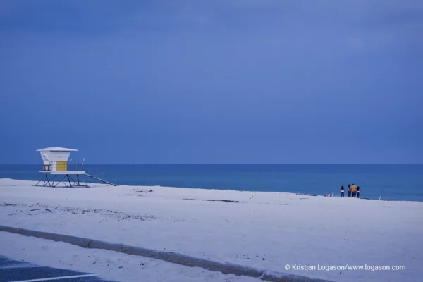 Family on a white sand beach at dusk in Louisiana