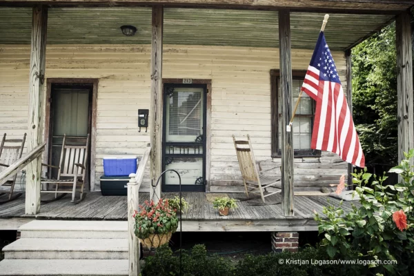American flag on a front porch of a wooden house in Pensacola, Florida