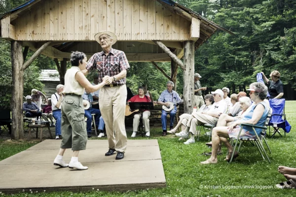 People dancing country dance in a state park by Mabry Mill