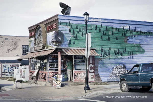 Decorated building in Grand Marais with fish sculpture and an pickup parked in front